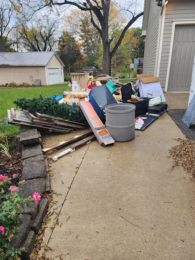 Dumpster being loaded with debris for Roofing Dumpster Rental in Lenox